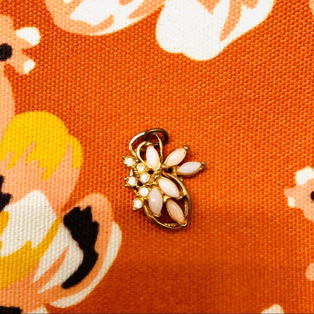 Gold toned necklace charm